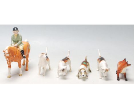 Beswick - A collection of early 20th Century ceramic figurines depicting a hunting scene including a huntsman, horse, dogs an