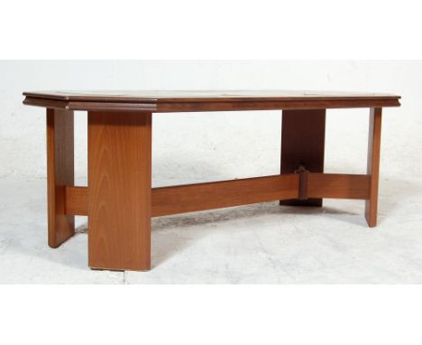 A vintage late 20th century teak wood tile top coffee table having hexagonal shaped top with brown tiles raised on four suppo