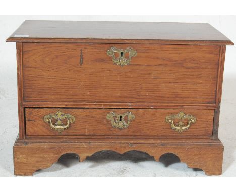 An early 20th century antique oak small proportions bed end blanket box having hinged lid over a single drawer with brass swi