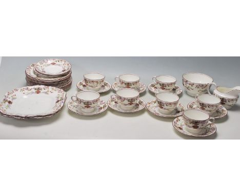 An early 20th century Aynsley fine english bone china tea service comprising of eight cup,saucers with side plate trios, crea