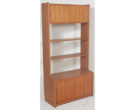 A retro vintage mid century teak wood wall unit / room divider by Gibbs having a twin sliding door cupboard over 3 shelves ra