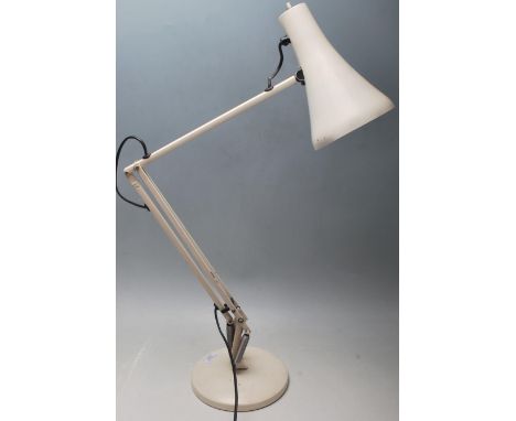 A retro vintage industrial articulated desk lamp in the manner of Herbert Terry having a pendant shade on twin arms over a ci