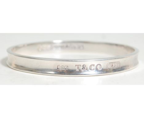 A vintage silver Tiffany bangle bracelet of typical round form with engraved T &amp; Co, the interior marked 2005 Tiffany &am