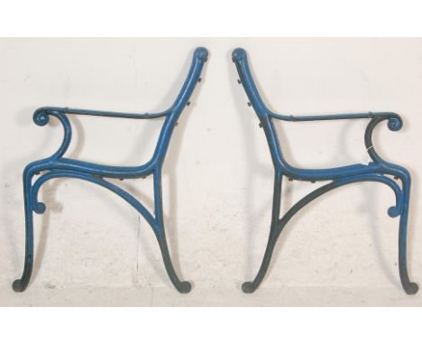 A pair of 20th Century&nbsp;antique &nbsp;cast iron scroll work garden bench ends painted in blue.