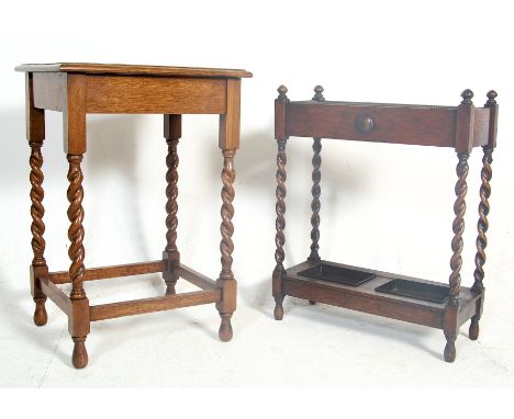 An early 20th Century Edwardian oak stick stand having a four finial top above beaded decoration set over a double cavity sup