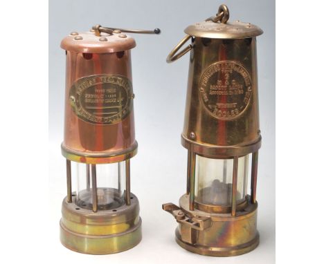 A pair of Victorian 19th century brass and copper miners lamps. Each of cylindrical form with brass makers plaques to the top