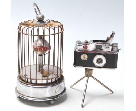 A vintage retro cigarette Photo-Flash lighter in the form of a film camera with spring loaded mechanism and compass to the fr