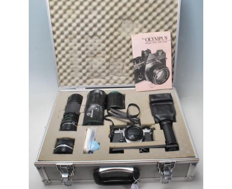 A vintage 20th century OLYMPUS OM- 1 N 35mm camera in a aluminium carry case along with flash, lenses and filters. Sigma zoom