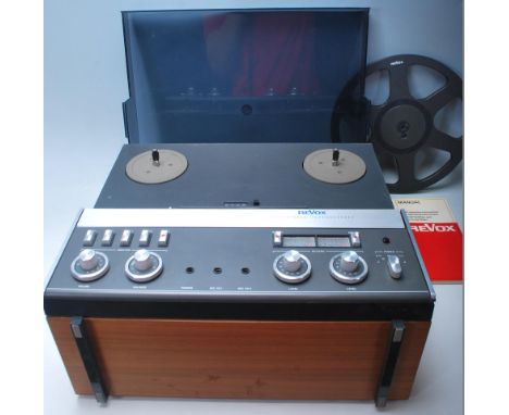 A vintage Revox A77 reel to reel stereo tape recorder having teak wood case, dark perspex dust cover / lid and brush aluminiu