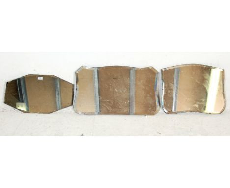 A group of three vintage retro mid Century frameless wall mirrors to include an octagonal example and two cartouche symmetric