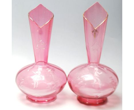 A pair of 19th Century Victorian cranberry glass stem vases of bulbous form having painted white enamel decoration of a young