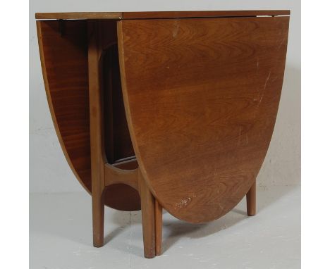 Nathan - A retro vintage 1960s drop leaf teak wood dining table by Nathan having an oval hinged top raised on a gate leg acti