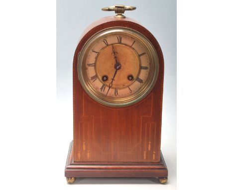 &nbsp;An early 20th Century Edwardian dome top mantel clock having an inlaid oak body with a brass and enamel clock face, rom