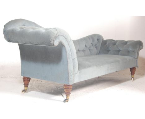 A Victorian 19th century double scroll end chesterfield sofa settee / chaise longue. Raised on turned mahogany legs with an o