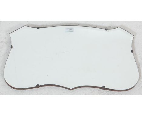 A 1920’s vintage wall hanging mirror in a shape of a shield with beveled glass mirror, oak back panel. Measures 82 cm x 36 cm