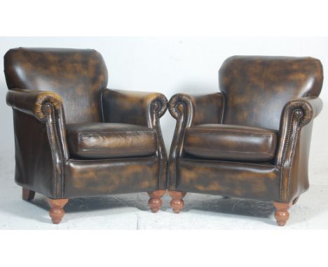 A pair of Antique style leather club - Chesterfield armchairs. Raised on turned legs with leather upholstered seats and backr