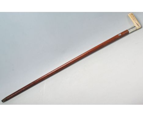 An early 20th Century bone and malacca gentleman's walking stick / promenade / cane. The walking stick having a carved bone h