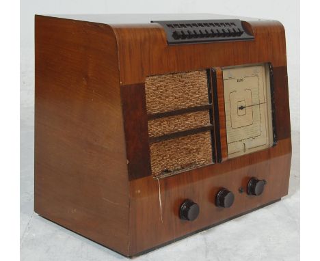 A 1920's EKCO Type P.B.510 walnut valve radio having a large glass dial to the right, front speaker to the left and three bak
