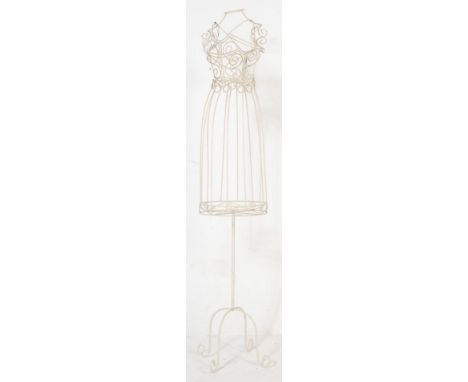 A vintage mid Century wire work shop display mannequin with scrolled detailing in the form of a dress raised on a column base