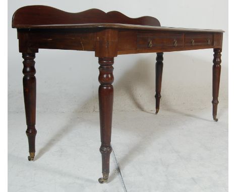 A 19th Century Victorian mahogany buffet de corps / serving table having a serpentine galleried back over a chamfered edge at