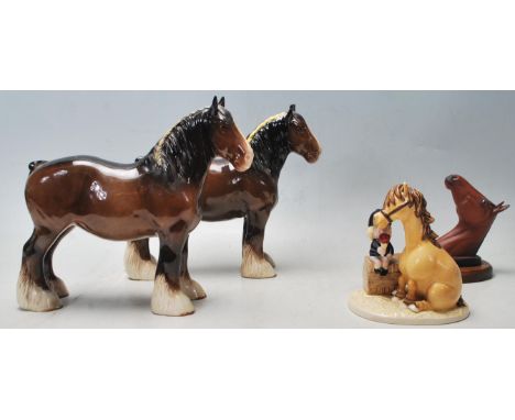 A collection of ceramic horses to include a Royal Doulton shire horse having a dark brown colourway with white hoofs along wi