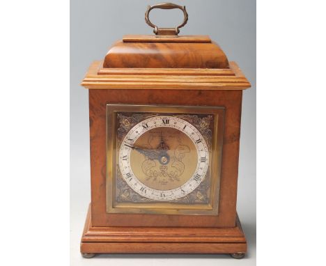 An Edwardian early 20th Century oak cased Elliot mantel clock, retailed by Garrard &amp; Co Ltd, having signed a brass and si