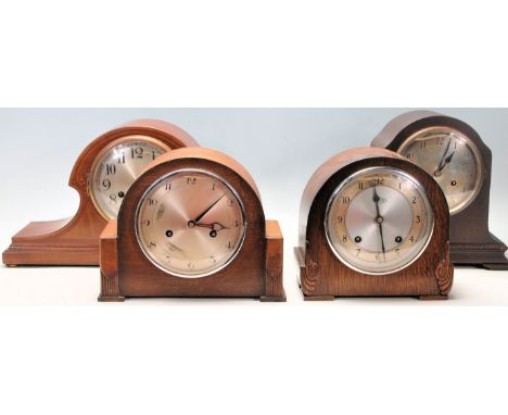 A collection of four early 20th Century Edwardian mantel clocks comprising of an inlaid mahogany Napoleon's Hat shaped mantle