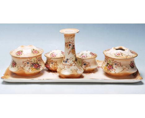 An early 20th Century Crown Ducal ivory blush " Louis " dressing set having floral decoration to include brush pot, candlesti