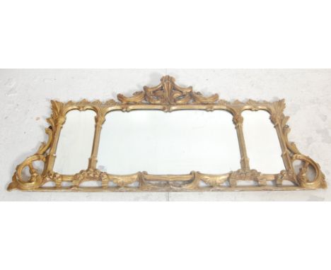 A 19th Century Regency gilt moulded mantel mirror having three mirror panels the frame being moulded and decorated with scrol