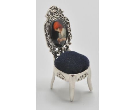 A silver 925 pin cushion in the form of a Thomas Chippendale chair having blue baize cushion to the seat and&nbsp;enamelled b