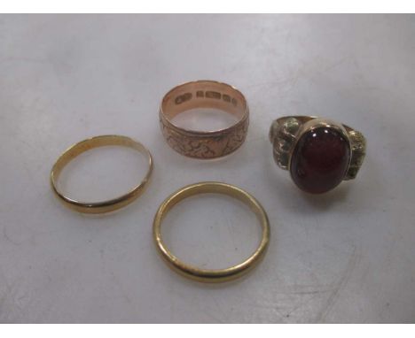 A collection of four rings including a hallmarked 9ct gold ring, a garnet ring tested as 9ct gold 9.2g, a hallmarked 18ct gol