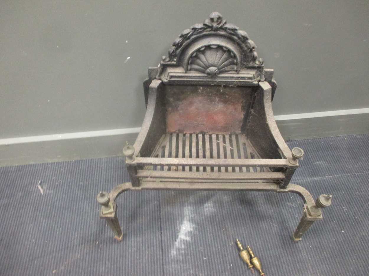 A Victorian fire grate with brass finials 67cm high and 65.5cm wide in