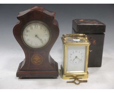 An Edwardian brass carriage clock with arabic numerals, the back stamped E M &amp; Co, together with fitted travelling case 1