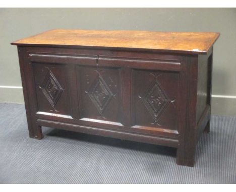 An early 18th century oak three panel coffer with carved lozenge decoration 62 x 113.5 x 47cm