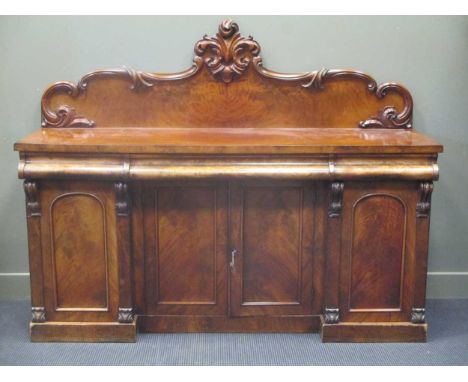A Victorian mahogany sideboard with shaped and carved back panel, fitted three frieze drawers with cupboards underneath, 143 