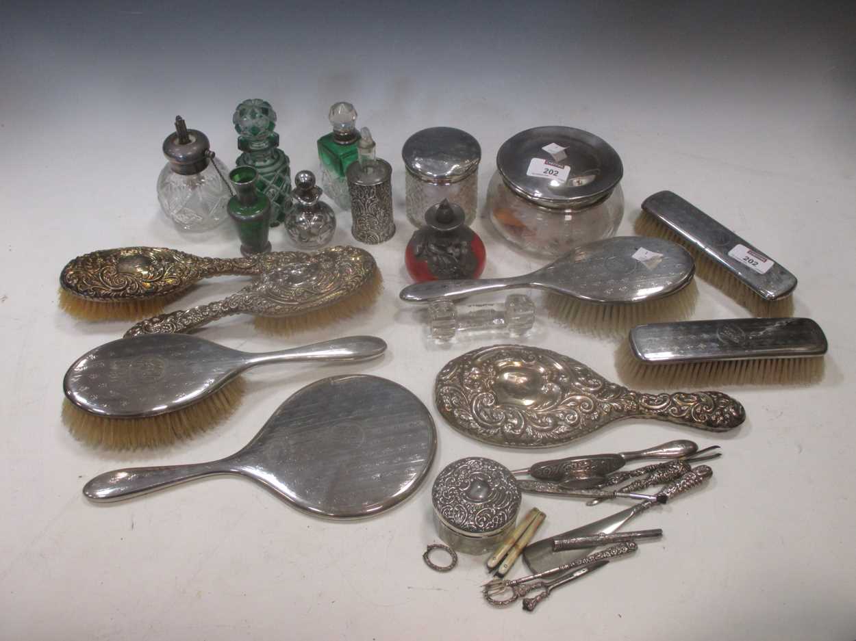 A collection of mostly silver mounted dressing table accessories, including brushes, mirrors, in