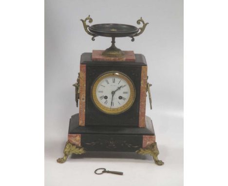 A late 19th century black marble mantel clock, drum movement, circular white enamel dial with Roman numerals inscribed 'Walla