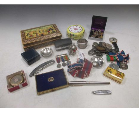 A collection of foreign banknotes and change together with some medals, a pocket watch, a wristwatch, some buttons, a napkin 