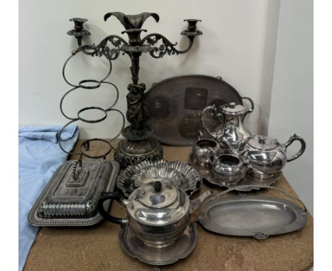 An electroplated three branch chandelier with three figures at its base together with an electroplated four piece tea service