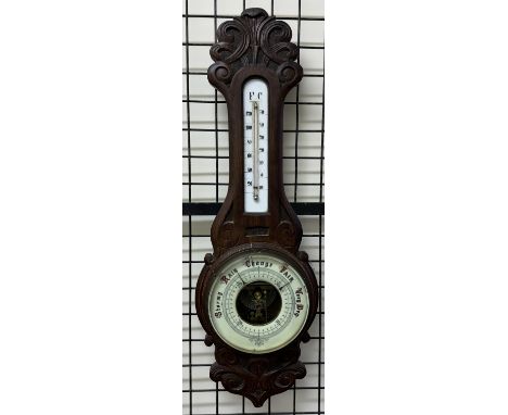 An aneroid barometer with an alcohol thermometer