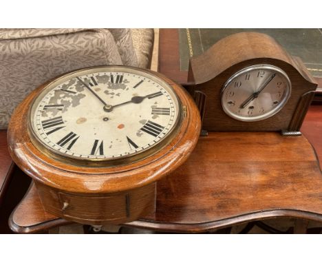 A railway type time piece with a circular dial and Roman numerals together with a an oak mantle clock 