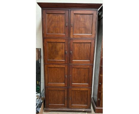 A mahogany cabinet with a moulded cornice above eight hinged cupboard doors on bracket feet, 106cm wide x 205cm high 