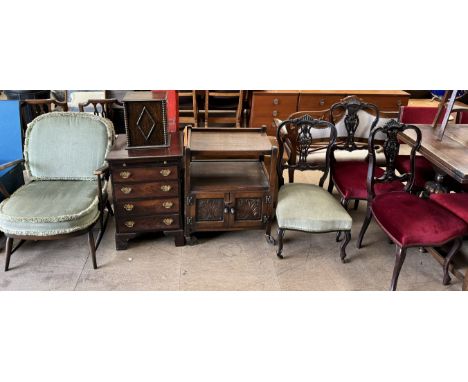 An Ercol elbow chair together with an oak smokers cabinet, a small chest of drawers, an oak tea trolley and three Edwardian s