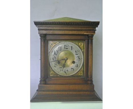 A late 19th century German bracket clock with walnut veneered case, the turned column supports enclosing a square cut dial wi