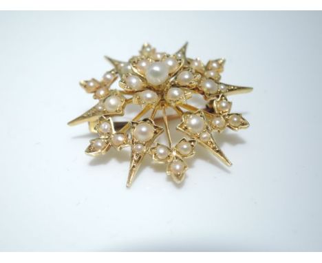 A Victorian seed pearl starburst pendant/brooch, in 15ct gold208 A Victorian clasp, of circular form centred with a cluster o