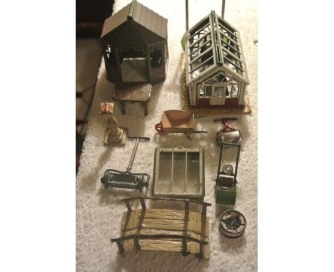 A collection of vintage lead model garden effects to include a gazebo, table, coventry greenhouse, sundial, wheelbarrow, two 