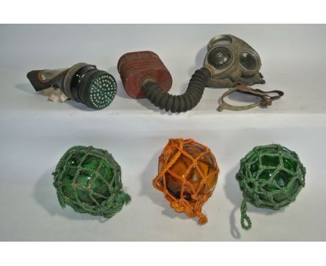 A Second World War medium sized gas mask stamped MB38 together with a further gas mask, a No 4A BW & M Ltd together with two 
