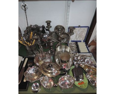 A collection of mostly plated wares to include a teapot with shaped outline with matching sugar bowl and milk jug, a two hand