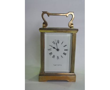 A brass carriage clock with reeded framework, white enamel dial and eight day timepiece, Mapping & Webb Limited