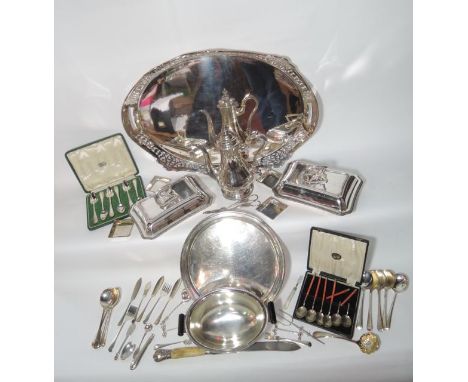 A selection of silver plated wares to include a pair of lidded serving dishes of canted rectangular form with embossed border